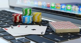 Four aces, deck of playing cards and colorful chips on computer laptop keyboard