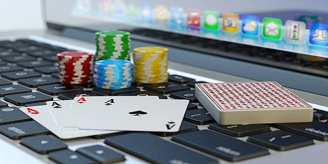 Four aces, deck of playing cards and colorful chips on computer laptop keyboard